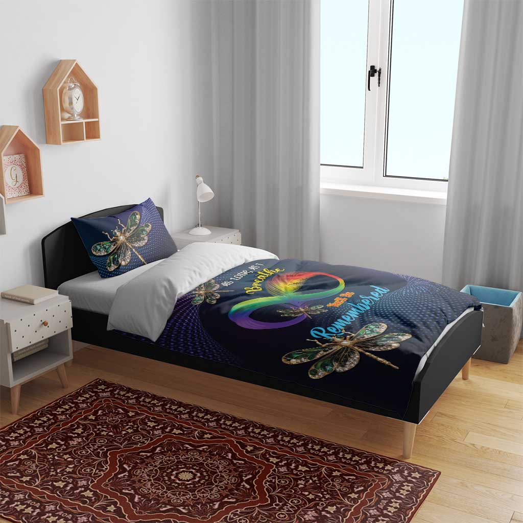 Navy bedding set with colorful dragonfly print, includes duvet and two pillows