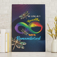 Canvas wall art with rainbow infinity feather and teal dragonflies on dark blue dots.