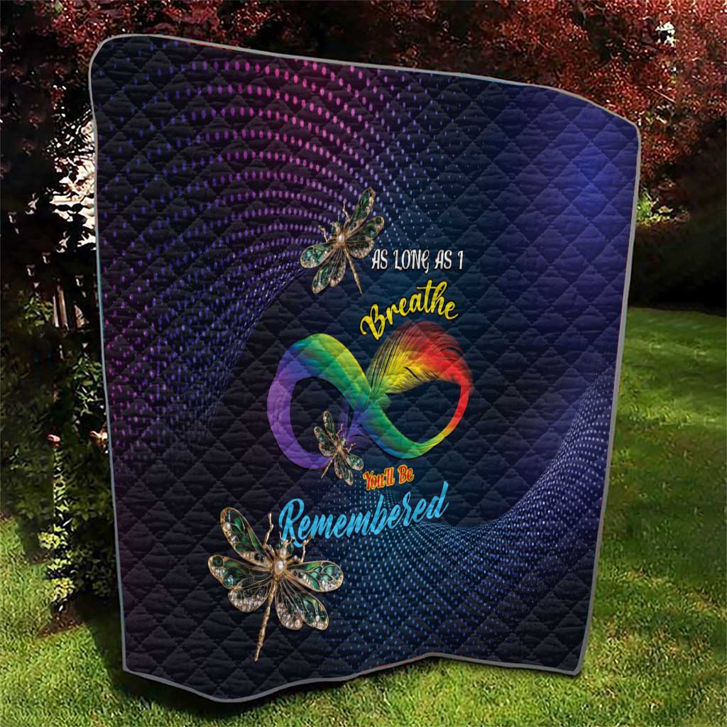 Navy quilt with diagonal quilting, rainbow heart graphic and dragonfly applique motifs