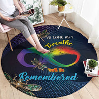 Round memorial carpet with dark navy dotted pattern, rainbow infinity loop and dragonfly art.