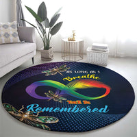 Round memorial carpet, dark navy with large rainbow infinity graphic and gold dragonflies.