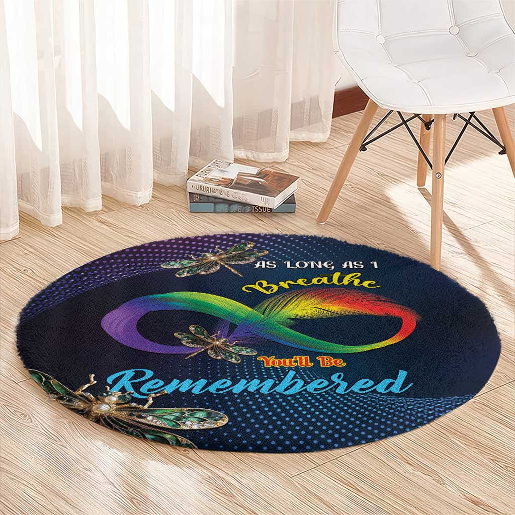 Round memorial carpet, dark navy with rainbow infinity design and dragonfly print on full surface.