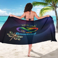 Navy sarong draped over shoulders; dotted texture and dragonfly feather artwork