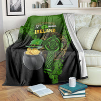 St. Patrick's Day blanket on sofa, green/black with Ireland text, shamrock and gold coin pot