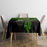 Rectangular black St. Patrick's tablecloth with green clover and Celtic emblem in center