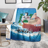Blue SABA sailboat blanket as a throw, displayed on a gray sofa seat