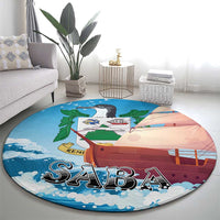Round sailboat carpet rug with illustrated ship, blue clouds, and “SABA” letters