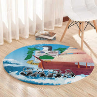Round sailboat themed carpet rug in blue with wave edge and “SABA” lettering