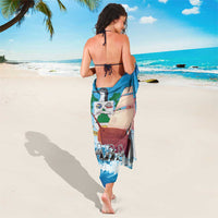 Blue sailboat sarong tied at waist, with SABA logo and wave pattern