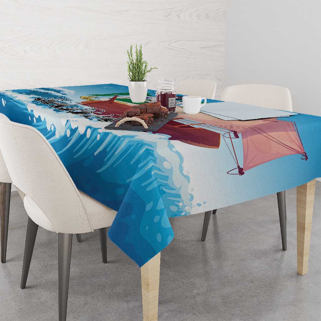 Blue sailboat tablecloth on a dining table with wave pattern and sailboat scene
