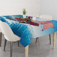 Blue sailboat tablecloth on a dining table with wave pattern and sailboat scene