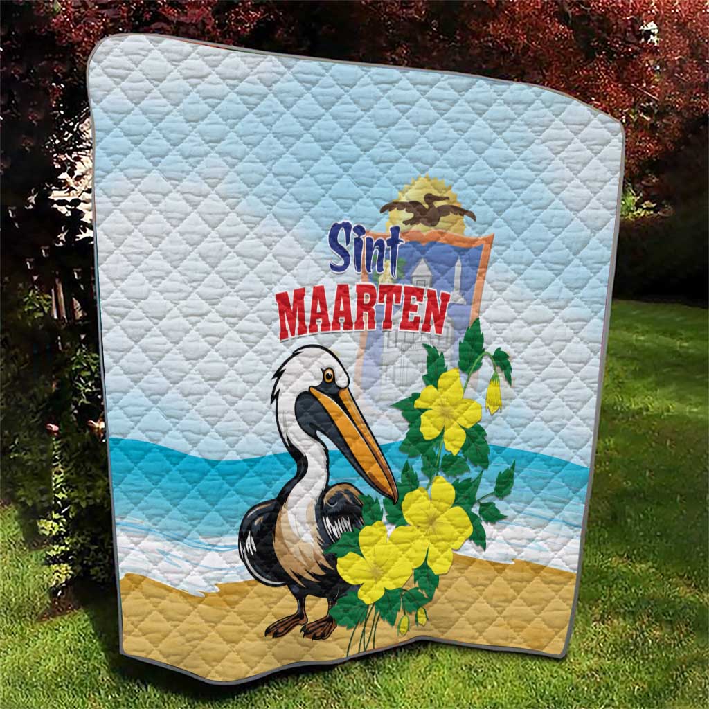 Light blue and tan quilt blanket with diamond stitching, pelican illustration and yellow flowers