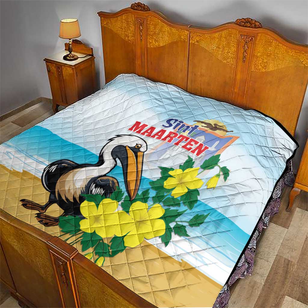 Blue and tan quilt blanket with diamond stitching, pelican graphic and yellow floral accents