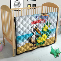 Light blue and tan quilt blanket with diamond stitching, pelican illustration and yellow flowers