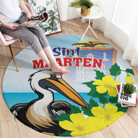 Round blue rug with pelican graphic and yellow blossoms; Sint Maarten text in center