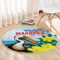 Round blue area rug with pelican and yellow flower print, centered Sint Maarten text