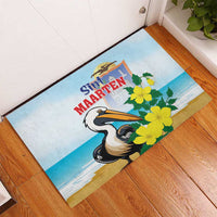 Blue rubber doormat with pelican and yellow flowers, entryway corner view