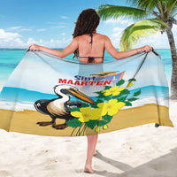 Light blue sarong with pelican, yellow blossoms, and Sint Maarten graphic across the fabric