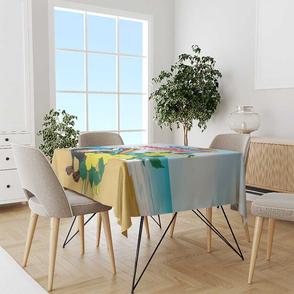 Blue tablecloth with pelican and yellow floral print, draped on dining table.