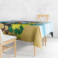 Blue tablecloth with pelican and green leaf pattern, overhanging edge detail.