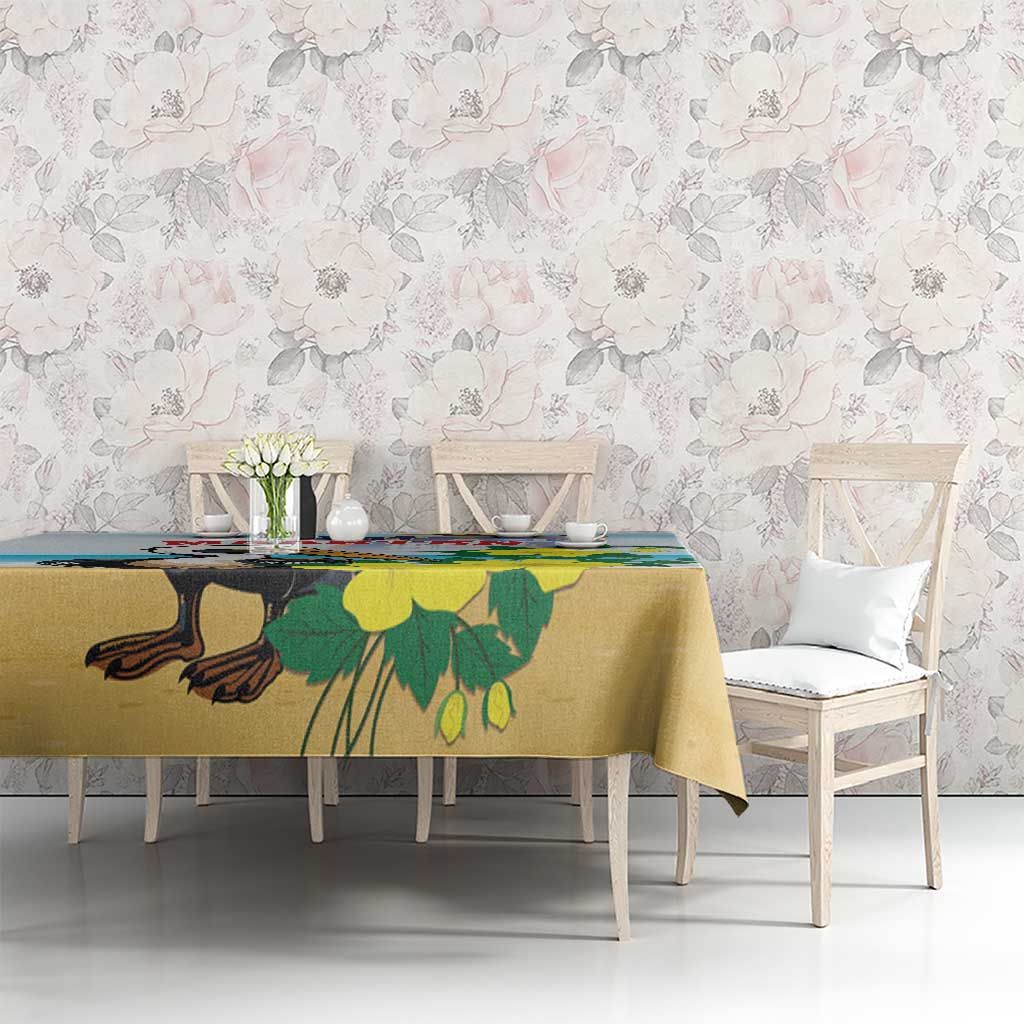 Blue tablecloth with pelican and foliage print, on rectangular dining table.
