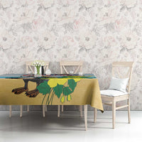Blue tablecloth with pelican and foliage print, on rectangular dining table.