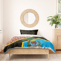 Bedding set on bed with black geometric accents, brown giraffe pattern, and blue emblem panel, yellow stripe