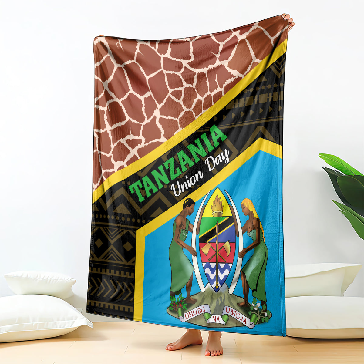 Blue-and-brown giraffe-pattern blanket with Tanzania-style text and emblem, draped