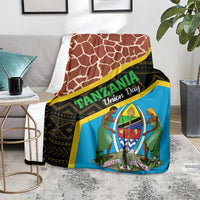 Giraffe-pattern blanket on sofa with blue emblem panel and yellow/black border