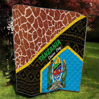 Tanzania Union Day quilt hanging on lawn, brown giraffe print and blue emblem panel