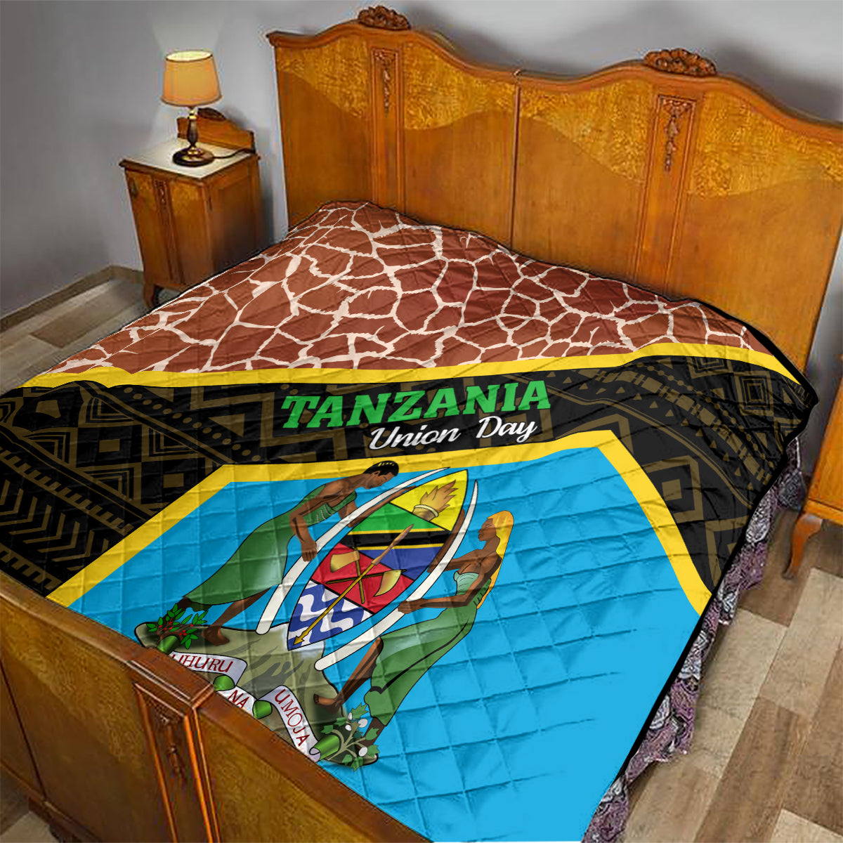 Tanzania Union Day quilt on wooden bed, brown giraffe pattern and blue emblem panel