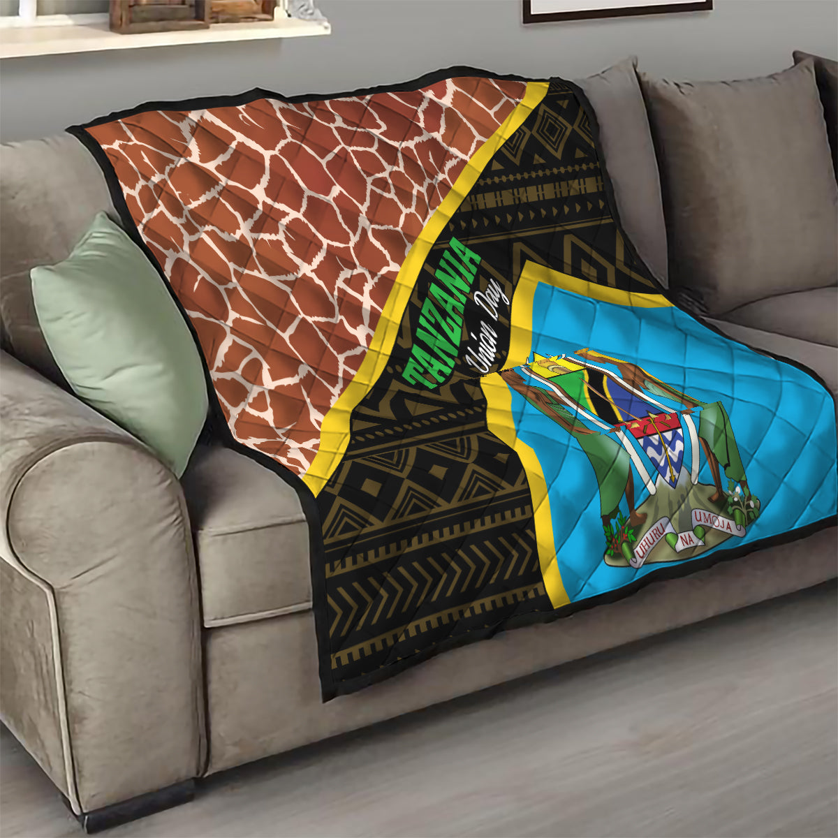 Tanzania Union Day quilt draped on sofa, brown giraffe print and blue emblem