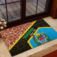 Brown rubber doormat with blue Tanzania Union Day emblem and black patterned border