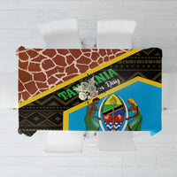 Giraffe-pattern tablecloth with blue centerpiece, yellow trim, and dark brown border