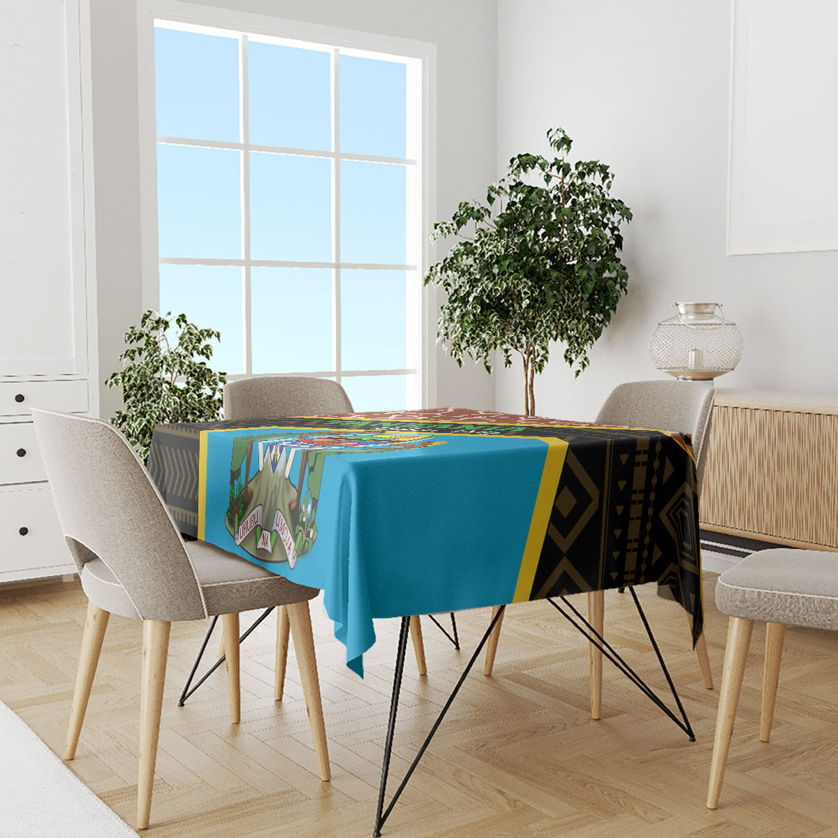 Tablecloth with blue center panel and dark patterned border over dining table