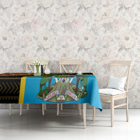 Giraffe-themed tablecloth with blue center, dark geometric band, and yellow edge on table