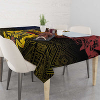 African patterned tablecloth with geometric border, dark green and red accents on dining set