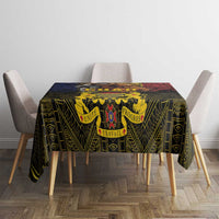 African patterned tablecloth with central crest, draped over square dining table
