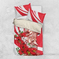 Red and white bedding set with two pillows; merlion and floral print design