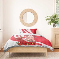 Red and white bedding set with two pillows; merlion illustration and orchid floral print