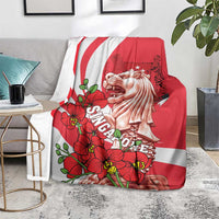Red and white Singapore themed blanket draped on sofa with Merlion artwork