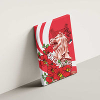 Red canvas wall art mounted on wall with lion statue head, flowers, and Singapore text