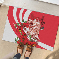 Red rubber doormat with merlion and orchids, shown with shoes on tile floor