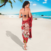 Red sarong with merlion and lion face print, white striped accents and floral cluster