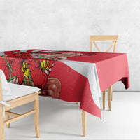 Red tablecloth draped over table with white diagonal band and Merlion orchid artwork.