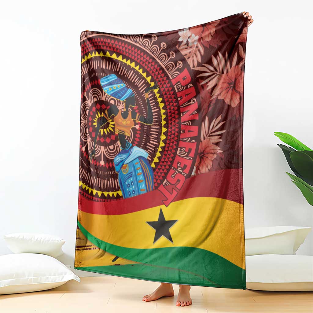 Ghana tropical print blanket draped over couch, maroon dancer scene and yellow star