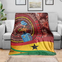 Ghana tropical print blanket on light gray sofa, woman figure in circle with yellow star