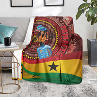 Ghana tropical print blanket on floor, maroon fabric with woman artwork and yellow star