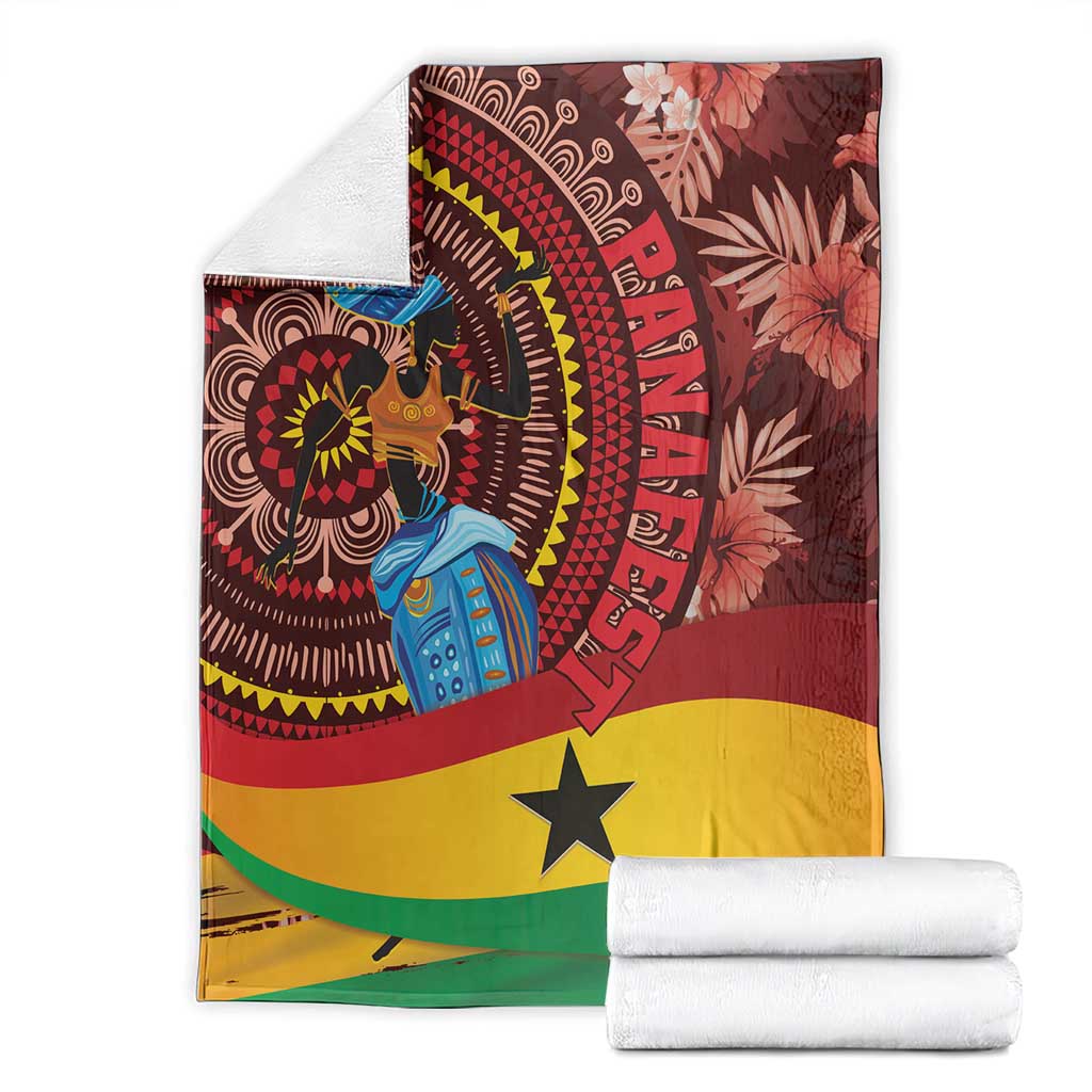 Ghana tropical print blanket with rolled towels, maroon circular figure and yellow star