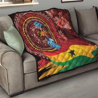 Panafest quilt draped on sofa, Ghana portrait medallion, maroon red, yellow, green, star